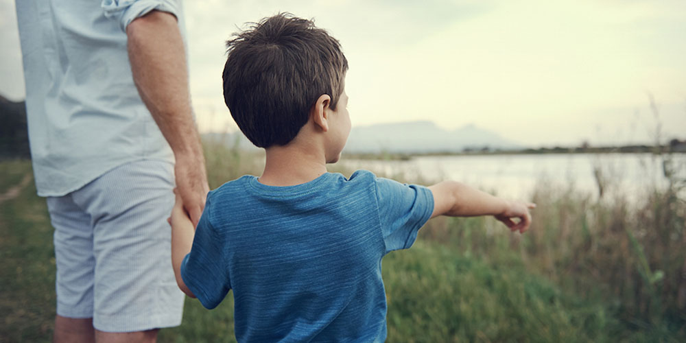 boy pointing at something outdoors