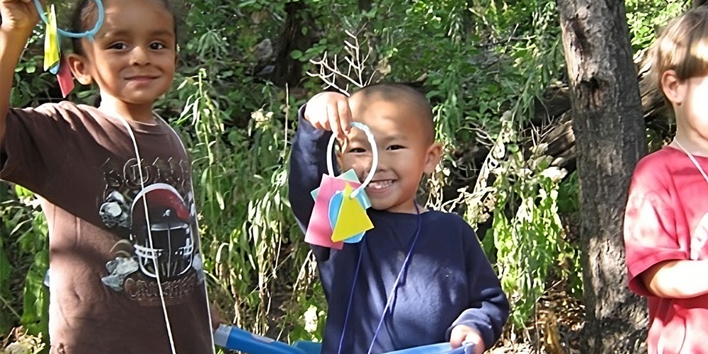 children holding up crafts they created