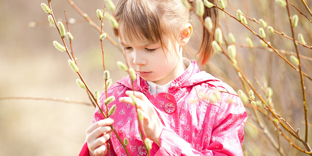 girl inspecting a branch