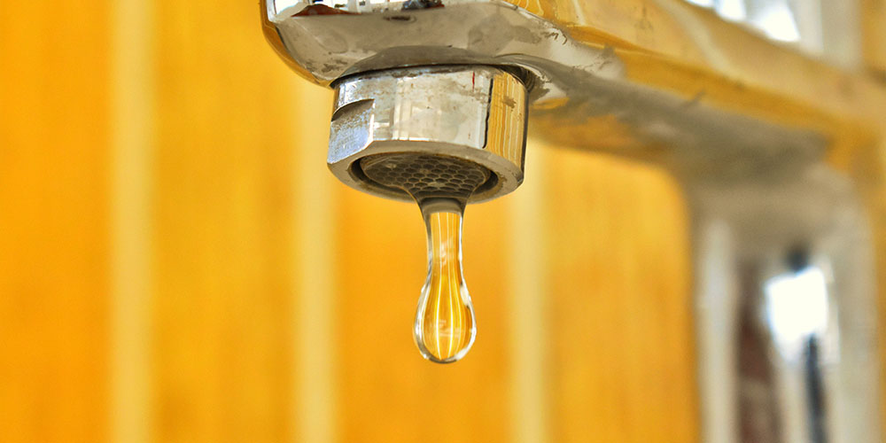 water dripping from a kitchen faucet
