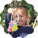 young child holding shapes