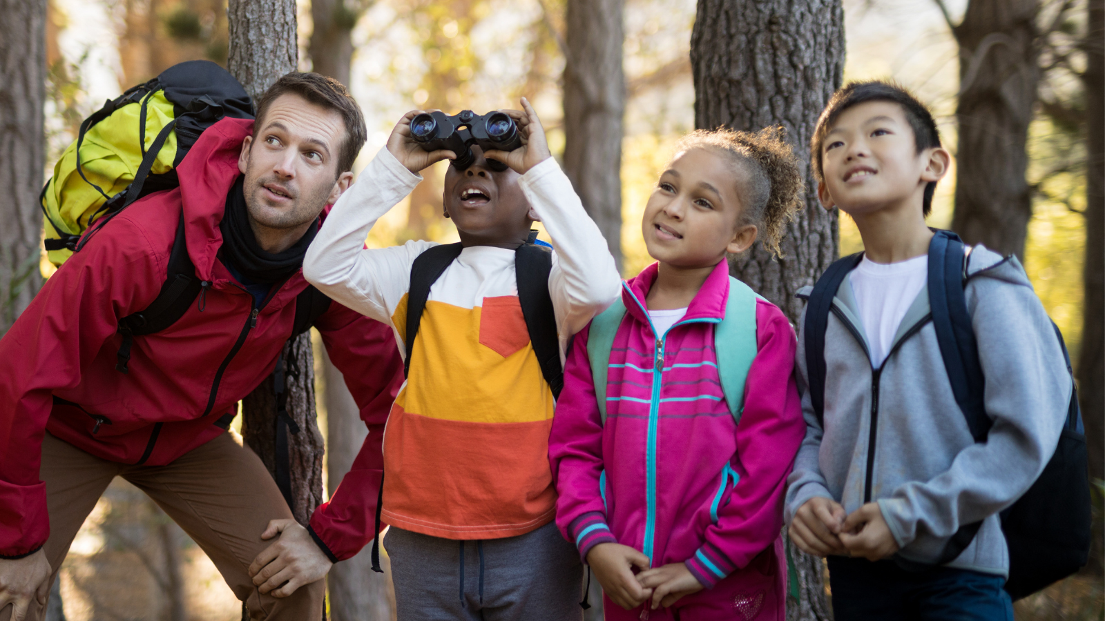 Adult and kids exploring in park