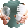 woman holding two types of light bulbs