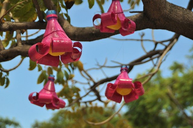 upcycled art hanging from tree