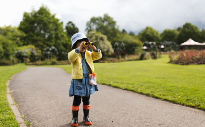 toddler girl playing exploration in spring park