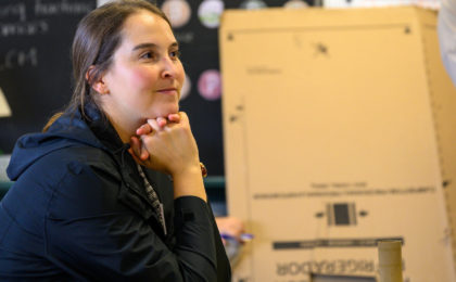 Female teacher sitting at desk of her classroom