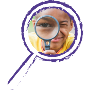 Young boy looks through magnifying glass