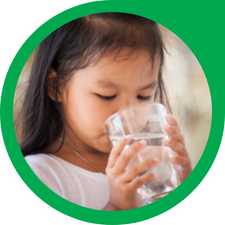 young girl drinking a glass of water